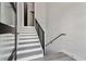 Bright staircase with modern railing, gray laminate flooring, and natural light at 3351 Fernleaf Dr, Hernando Beach, FL 34607
