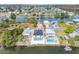 Aerial view of waterfront homes on canals with lush greenery and clear water views at 3380 Holly Springs Dr, Hernando Beach, FL 34607