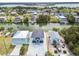 Aerial view of waterfront homes along a canal with lush greenery and clear blue skies at 3380 Holly Springs Dr, Hernando Beach, FL 34607