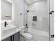 Modern bathroom with white marble tiled walls, black fixtures, and a sleek vanity at 3380 Holly Springs Dr, Hernando Beach, FL 34607
