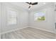 Empty bedroom featuring bright windows, recessed lighting, and light wood floors at 3380 Holly Springs Dr, Hernando Beach, FL 34607