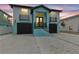 Two-story home with a black roof, garages, balconies, and a striking blue and light-blue color scheme at 3380 Holly Springs Dr, Hernando Beach, FL 34607