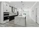Bright, open-concept kitchen with stainless steel appliances, a large island, and modern lighting fixtures at 3380 Holly Springs Dr, Hernando Beach, FL 34607