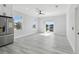 Bright kitchen area with stainless steel refrigerator and sliding glass doors to exterior at 3380 Holly Springs Dr, Hernando Beach, FL 34607