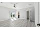 A spacious main bedroom with light, modern flooring and a sliding glass door to the balcony at 3380 Holly Springs Dr, Hernando Beach, FL 34607