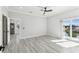 A bright main bedroom with light, modern flooring and access to the kitchen and balcony at 3380 Holly Springs Dr, Hernando Beach, FL 34607
