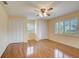 Bright bedroom with wood floors, ceiling fan and closets at 2329 Lancaster Dr, Sun City Center, FL 33573
