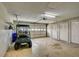 Spacious garage with golf cart, storage cabinets, and overhead door at 2329 Lancaster Dr, Sun City Center, FL 33573