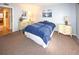Bedroom with blue bedding and ample closet space at 4746 Azalea Dr # 109, New Port Richey, FL 34652