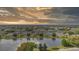 Picturesque community surrounds a lake, creating a peaceful atmosphere under a beautiful sky at sunset at 2410 Lancaster Dr, Sun City Center, FL 33573