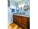 Charming bathroom featuring a wooden vanity with a marble countertop and modern fixtures at 2410 Lancaster Dr, Sun City Center, FL 33573