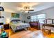 Bright bedroom with hardwood floors, a ceiling fan, and ample natural light at 2410 Lancaster Dr, Sun City Center, FL 33573