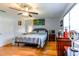 Cozy bedroom featuring hardwood floors, a ceiling fan, and ample natural light at 2410 Lancaster Dr, Sun City Center, FL 33573