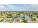 Well-maintained home with a charming facade, showcasing a serene lake view and verdant surroundings at 2410 Lancaster Dr, Sun City Center, FL 33573