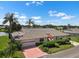 Beautiful single story home with mature landscaping, an attached garage, and a brick driveway at 2410 Lancaster Dr, Sun City Center, FL 33573