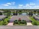 Charming home with a well-manicured lawn and a serene lake in the backdrop at 2410 Lancaster Dr, Sun City Center, FL 33573