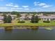 Charming single-story home boasts a beautiful lake view and lush landscaping with mature trees at 2410 Lancaster Dr, Sun City Center, FL 33573