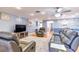 Comfortable living room with hardwood floors, a ceiling fan, and stylish decor at 2410 Lancaster Dr, Sun City Center, FL 33573