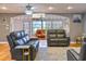 Comfortable living room featuring hardwood floors, decorative divider, and natural light at 2410 Lancaster Dr, Sun City Center, FL 33573