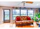 Cozy sunroom with floral-print seating, hardwood floors, and a bright view of the water at 2410 Lancaster Dr, Sun City Center, FL 33573