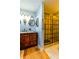 Bathroom features a large vanity and a walk-in shower at 2410 Lancaster Dr, Sun City Center, FL 33573