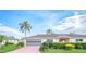 Single-story home with attached garage and neatly landscaped front yard at 2410 Lancaster Dr, Sun City Center, FL 33573