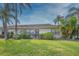 Front view of house with landscaping and a patio area at 2410 Lancaster Dr, Sun City Center, FL 33573