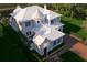Aerial view of a luxury home with a distinct turret, surrounded by mature landscaping at 5009 W Spring Lake Dr, Tampa, FL 33629