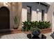 Charming courtyard featuring decorative tile, potted plants, and an inviting entryway at 5009 W Spring Lake Dr, Tampa, FL 33629