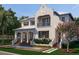 Elegant two-story home features a private balcony, lush landscaping, and a serene water feature at 5009 W Spring Lake Dr, Tampa, FL 33629