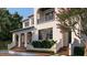 Elegant two-story home features a private balcony, lush landscaping, and a serene water feature at 5009 W Spring Lake Dr, Tampa, FL 33629