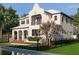 Elegant two-story home features a private balcony, lush landscaping, and a serene water feature at 5009 W Spring Lake Dr, Tampa, FL 33629