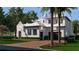 Beautiful home with a distinctive design, palm trees, a brick driveway, and manicured landscaping at 5009 W Spring Lake Dr, Tampa, FL 33629