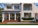 Elegant home featuring a pristine pool, lush plants, and refined architectural details at 5009 W Spring Lake Dr, Tampa, FL 33629