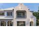 Close-up of the upper level of a beautiful home with blue accents and stylish architectural details at 5009 W Spring Lake Dr, Tampa, FL 33629