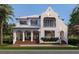 Expansive home showcasing a well-maintained lawn, a sparkling pool, and stately architectural design at 5009 W Spring Lake Dr, Tampa, FL 33629