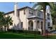 Elegant home with a manicured lawn, dark metal fence, and lush tropical landscaping for added privacy at 5009 W Spring Lake Dr, Tampa, FL 33629