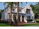 Stately exterior of a home featuring a well-kept lawn, privacy fence, and beautiful palm trees in the front yard at 5009 W Spring Lake Dr, Tampa, FL 33629