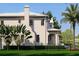 Expansive home with elegant details, lush landscaping, and a well-maintained lawn at 5009 W Spring Lake Dr, Tampa, FL 33629