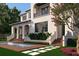 Elegant two-story home features a private balcony, lush landscaping, and a serene water feature at 5009 W Spring Lake Dr, Tampa, FL 33629