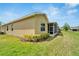 Rear view of house highlighting the screened patio and landscaping at 2121 Sifield Greens Way # 64, Sun City Center, FL 33573