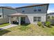 Elevated perspective of the fenced backyard and patio area at 9358 Rally Spring Loop, Wesley Chapel, FL 33545