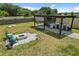 Outdoor kitchen and fire pit area in backyard at 9358 Rally Spring Loop, Wesley Chapel, FL 33545