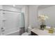 Clean and bright bathroom featuring a shower and tub combination at 9358 Rally Spring Loop, Wesley Chapel, FL 33545