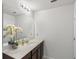 Clean bathroom with modern vanity and large mirror at 9358 Rally Spring Loop, Wesley Chapel, FL 33545