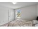 Cozy bedroom with neutral decor, carpeted floors, and natural light at 9358 Rally Spring Loop, Wesley Chapel, FL 33545