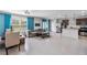 Open-concept living room, dining area, and kitchen with tile flooring at 9358 Rally Spring Loop, Wesley Chapel, FL 33545