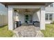 Covered patio with seating area, perfect for outdoor relaxation at 9358 Rally Spring Loop, Wesley Chapel, FL 33545