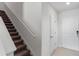 Carpeted staircase with white railing and white entryway at 9358 Rally Spring Loop, Wesley Chapel, FL 33545