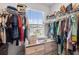 Spacious walk-in closet with ample shelving and hanging rods at 9358 Rally Spring Loop, Wesley Chapel, FL 33545